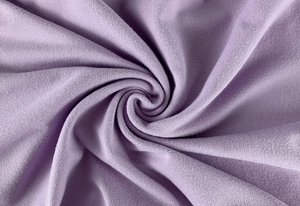 Macro shot of soft light purple ruched fabric texture for a bodycon dress
