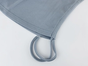 Detailed view of rib-knit fabric texture with adjustable drawstring and neat stitching