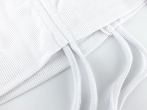 Detailed close-up of white ribbed fabric texture and adjustable drawstring on the top