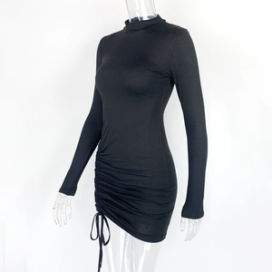 Detail view of the side drawstring ruched design on this black slim long sleeve dress
