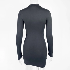 Detail of the back view of a slim-fit black long-sleeve mini dress on a mannequin