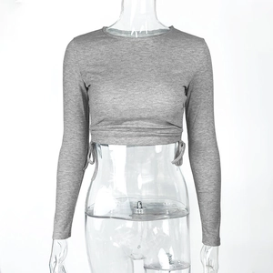 Detail of grey ribbed long sleeve crop top featuring adjustable drawstring hem detail