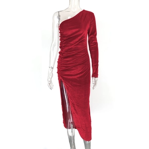 Detail view of red velvet dress featuring asymmetrical one-shoulder and ruched high slit