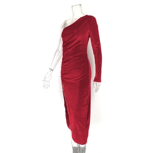 Close-up of red velvet dress featuring asymmetric one-shoulder design and ruched side details