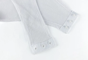 Detail view of the secure triple snap-button closure on ribbed cotton bodysuit