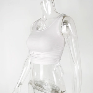 Detail view of white ribbed knit crop top with adjustable side drawstring ruching detail