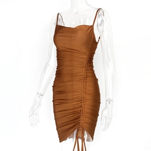 Detail of ruched brown bodycon dress showing drawstrings and pleated elastic fabric