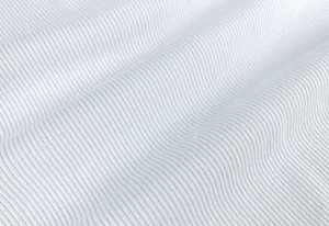 Close-up of premium white ribbed cotton fabric with vertical knit texture details