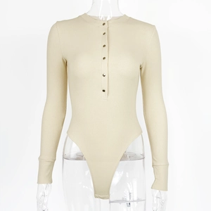 Close-up of beige ribbed bodysuit with long sleeves and gold buttons on the neckline