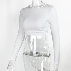 Detailed view of white ribbed knit fabric and drawstring side ruching on cropped top