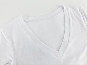 Detail view of the V-neckline stitching and premium cotton texture on a white bodysuit
