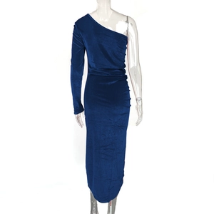 Detail showing deep blue velvet fabric texture and side pleats on the evening dress