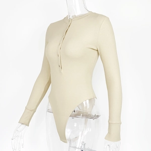 Close-up of beige ribbed knit bodysuit featuring Henley neckline with button closure