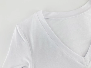 Detail shot of the reinforced V-neck stitching on white long sleeve bodysuit