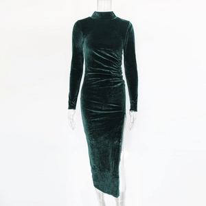 Detail of ruched waist and high side slit on an elegant dark green velvet dress