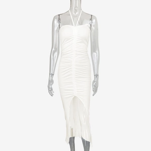 Close-up of white ruched bodycon dress featuring front slit and halter neck detail