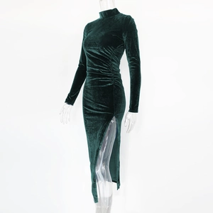 Detail view of emerald green velvet dress with elegant side pleats and high slit