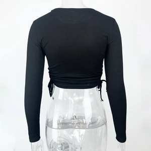 Detailed back view of black ribbed knit crop top with adjustable drawstring hem details