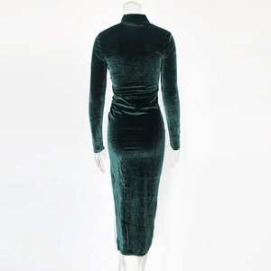 Detailed macro view of dark green velvet fabric texture on elegant long sleeve dress