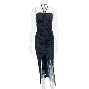 Detail of ruched texture and center high slit on a black bodycon tube dress