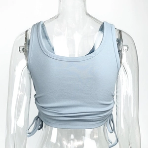 Detail of light blue ribbed knit fabric and adjustable side drawstrings on crop top