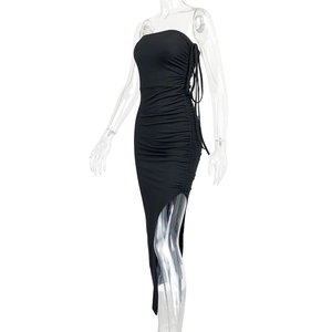 Detail of side drawstring ruching and high slit on a black bodycon tube midi dress