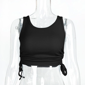 Detail of black ribbed crop top with side drawstring ties and ruched fabric texture