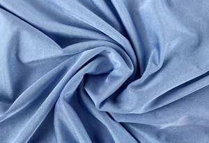 Macro shot of light blue ribbed knit fabric showing soft texture and subtle glossy finish