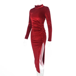 Detail of burgundy velvet dress featuring elegant ruched waist and high side slit