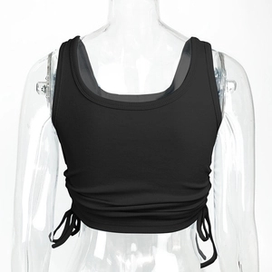 Detail of ribbed knit crop top featuring side adjustable drawstrings and ruched texture