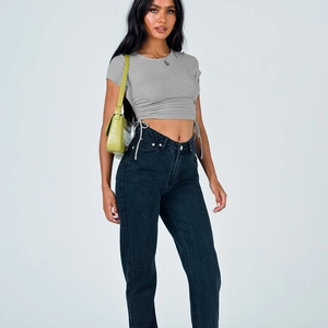 Detail view of grey drawstring crop top paired with high-waisted black straight jeans