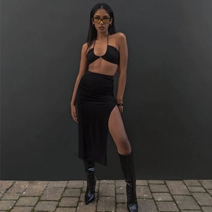 Detail of black halter crop top and side slit midi skirt set for a sleek summer look