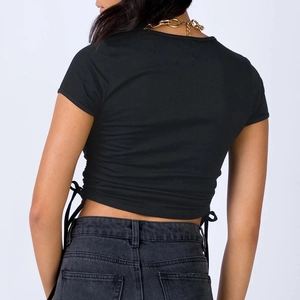 Detail view of the drawstring side ties and ruched texture on this black slim crop top