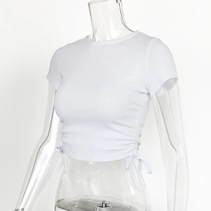 Close-up of the adjustable side drawstring and ribbed knit texture on the white crop top