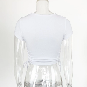 Detail view of white ribbed cotton crop top featuring side drawstring ruched accents