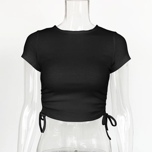 Detail view of black ribbed knit texture and side ruched drawstring on the crop top