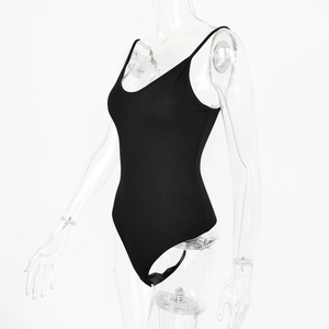 Detail of black bodysuit featuring slim shoulder straps and snap closure at bottom