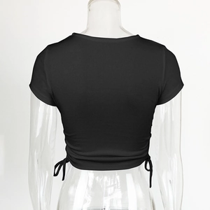 Detail view of black ribbed crop top showing side drawstring and vertical knit texture