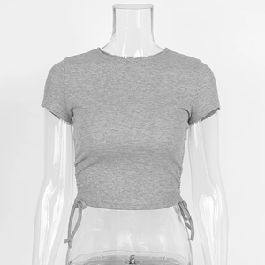 Close-up of grey ribbed knit crop top featuring side drawstring details and round neck