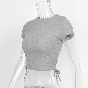 Detail view of grey ribbed knit crop top with side drawstring ruched adjustment