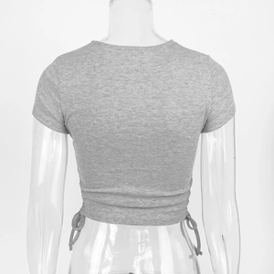 Detail of adjustable drawstring back on a grey ribbed knit short sleeve crop top shirt