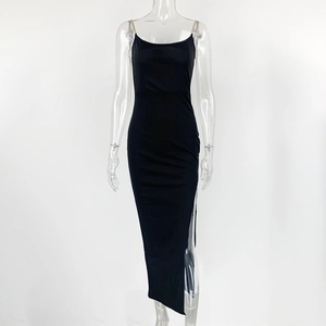Detail view of black bodycon dress with gold chain straps and a high side slit feature