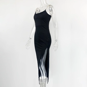 Detail view of the black bodycon dress featuring gold chain straps and a high side slit