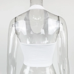 Detail of white ribbed knit halter top featuring backless design and vertical texture