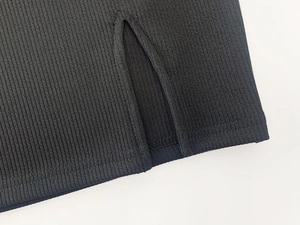 Detail von schwarzem Rippstrick mit Schlitz am Saum und hochwertiger Doppelnaht