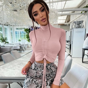 Pink high-neck cropped long sleeve top with ruched drawstring and snakeskin mini skirt