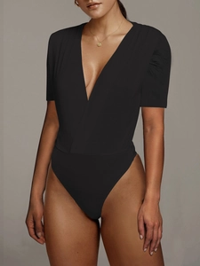 Detail of elegant black deep V-neck bodysuit with pleated short sleeves and slim fit design