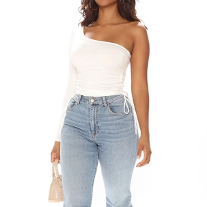 Detail of white one-shoulder slim fit top featuring adjustable side drawstring ruching