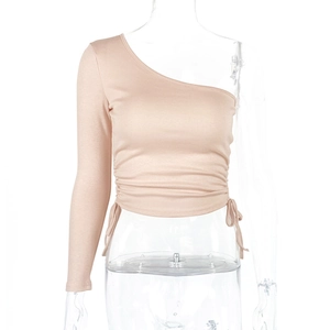 Detail of ruched drawstring side on nude one-shoulder cropped long sleeve top