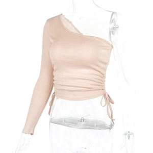 Close-up of beige off-shoulder crop top featuring side drawstring and ruched texture details